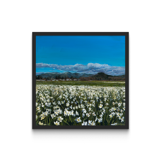 Framed painting of a field of daffodils with a mountain in the distance.