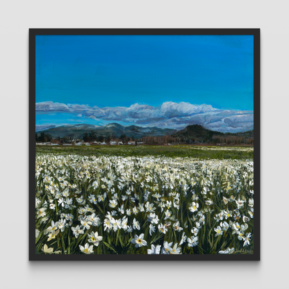 Framed painting of a field of daffodils with a mountain in the distance.