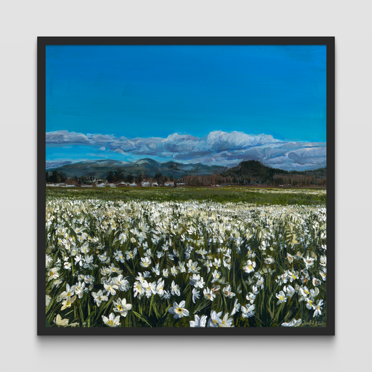 Framed painting of a field of daffodils with a mountain in the distance.