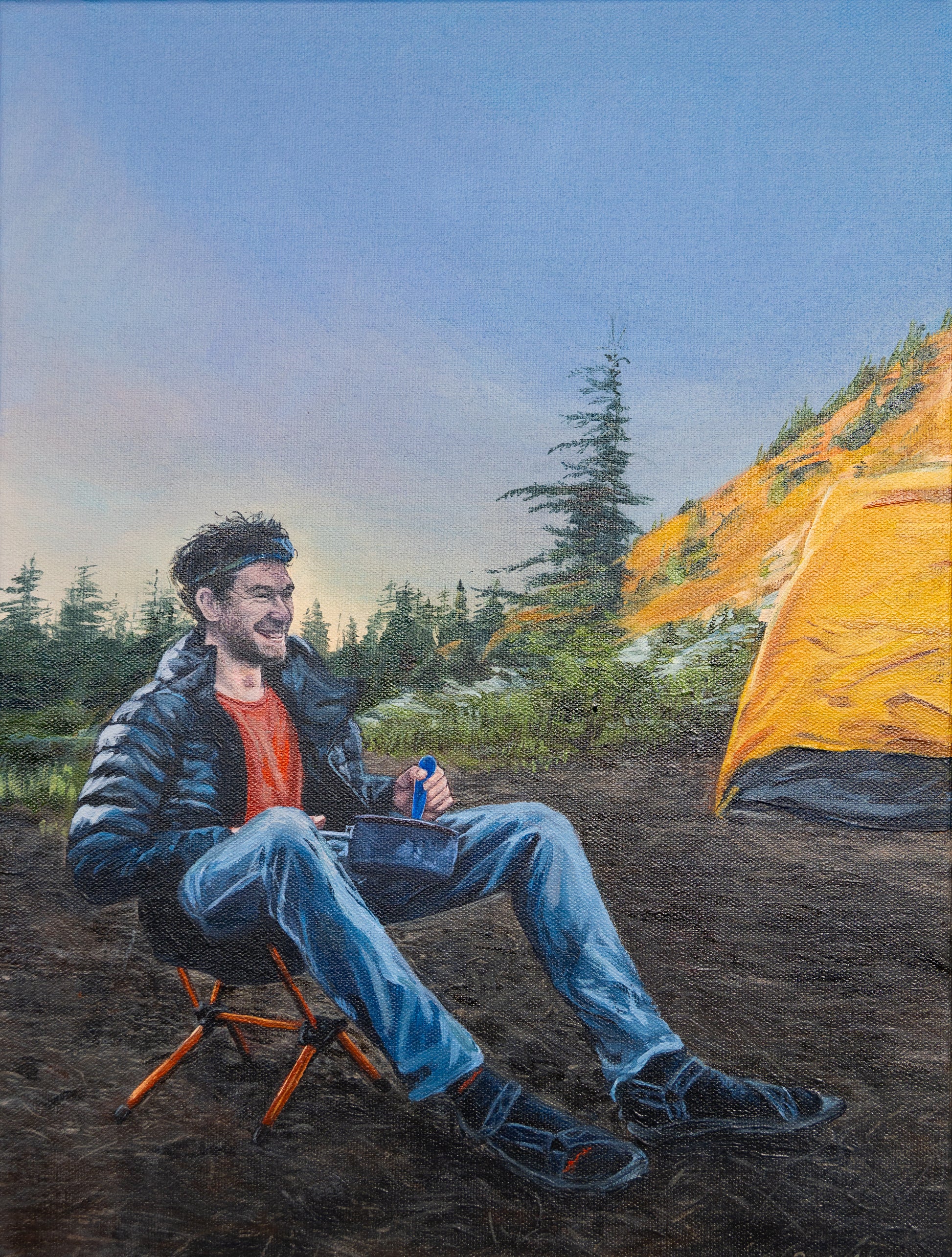 A realistic painting of a man sitting in a camp chair while eating from a sauce pan. He is smiling, looking to the right. He has brunette curly hair and a short beard and is wearing a puffy black jacket, grey hiking pants, a red shirt, and a headlamp. A yellow tent is in the background, as well as a forest of evergreen trees. The sun is low and casting a golden light on a hill in the distance.