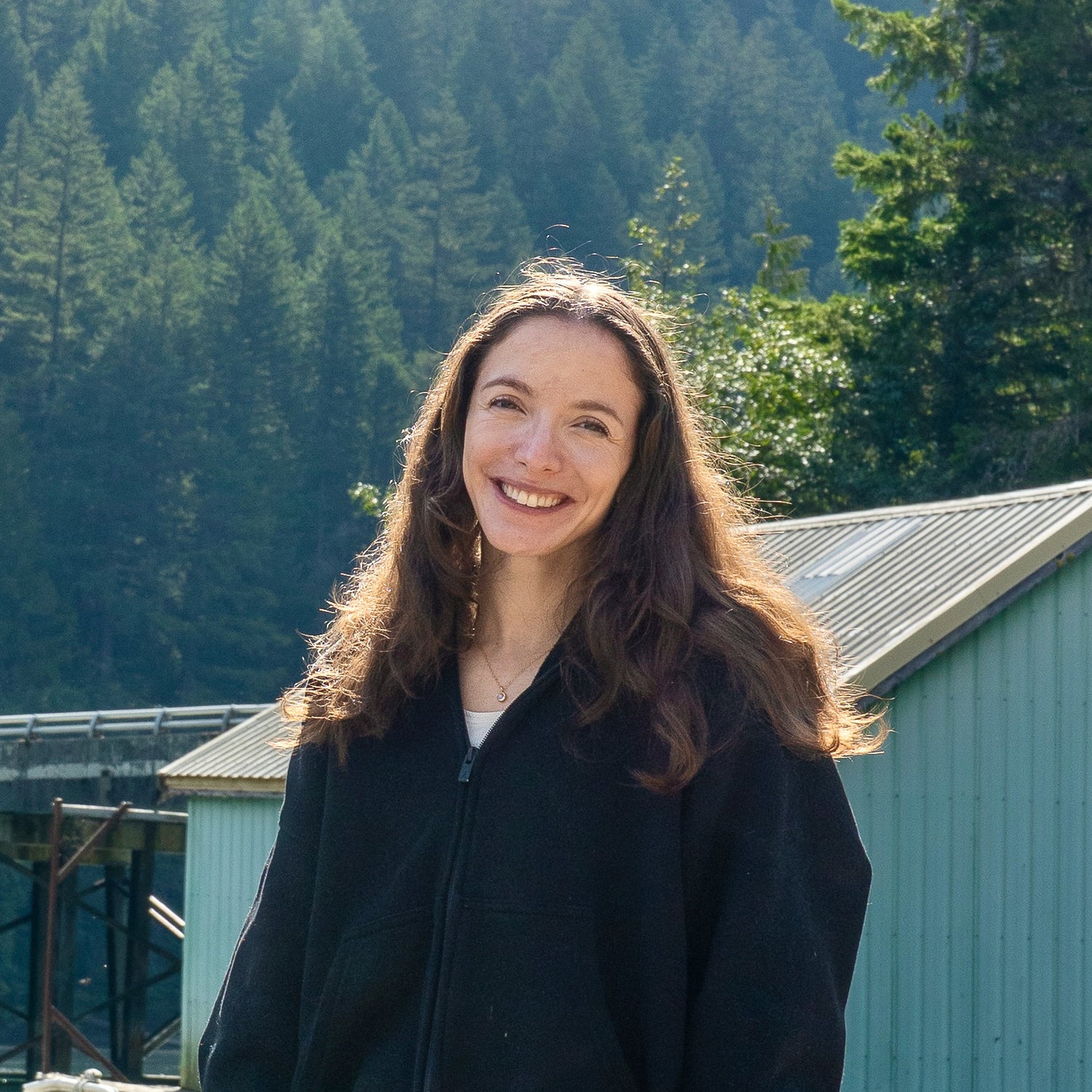 Woman smiling with a forest background