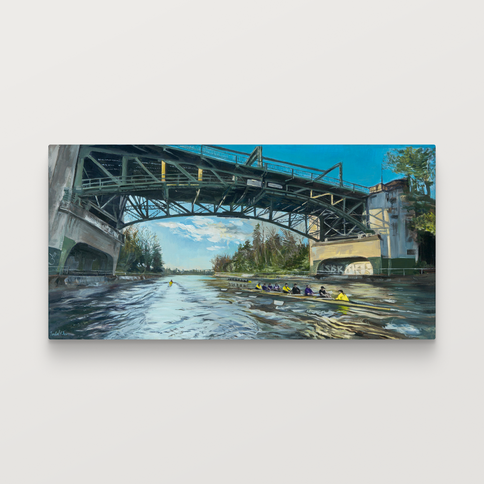 Framed artwork of a bridge over a river with rowers.