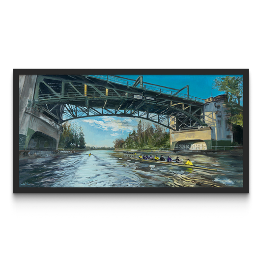 Framed artwork of a bridge over a river with rowers.