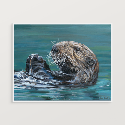 Print of a painting of a sea otter in water on a white wall
