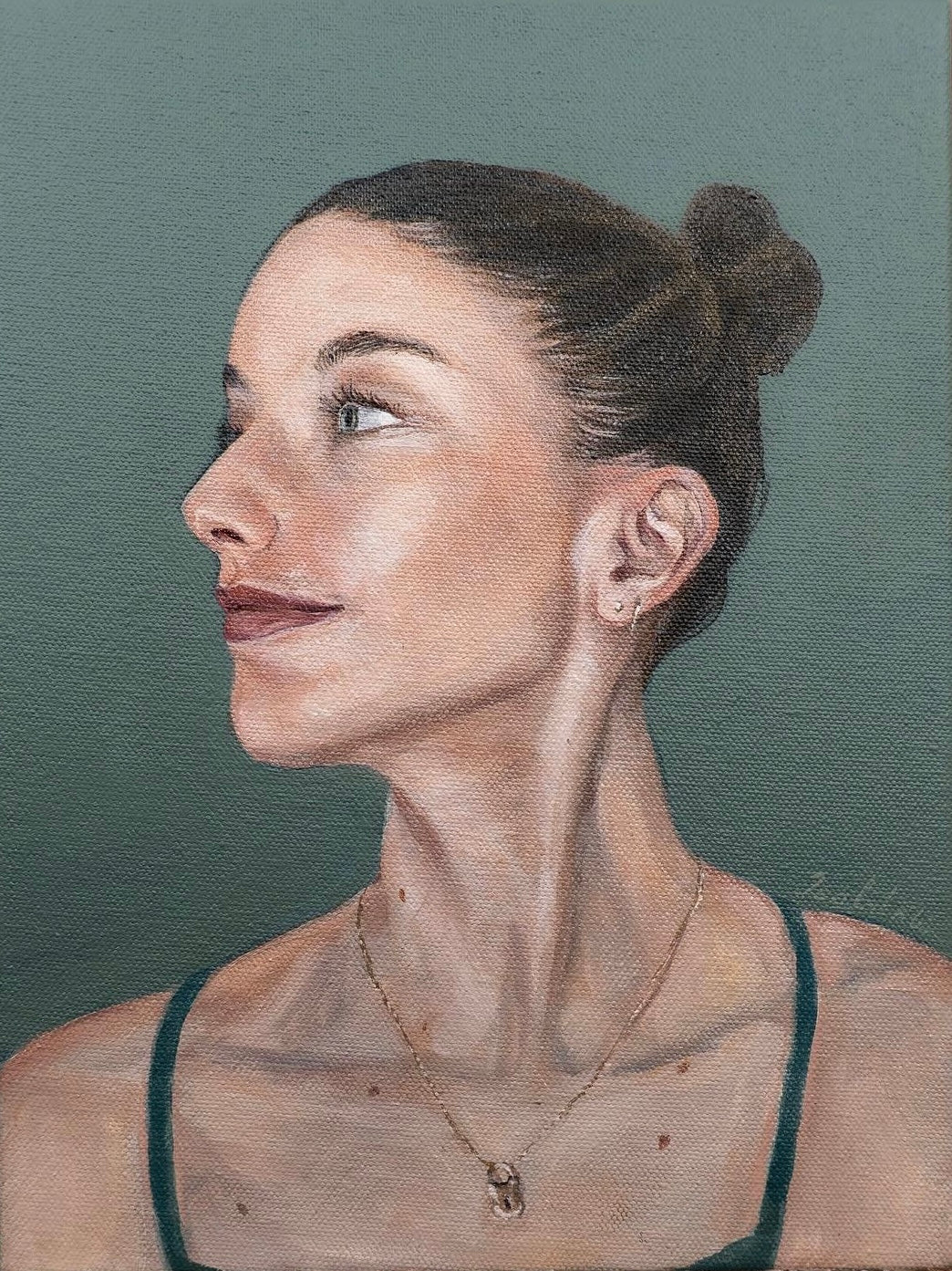 A realistic acrylic portrait painting of a women looking to her right. She wears her brunette hair in a high bun. The background is a blue-green, matching her eyes.