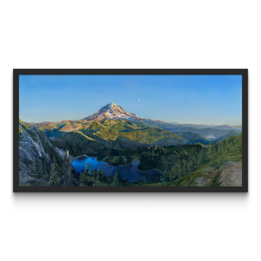 A framed painting hung on a white wall.

The painting is a vibrant realistic landscape of Mount Rainier in the summer. It overlooks Mowich Lake. The sun is setting, casting golden light on the mountain and surrounding hills. The moon can be seen faintly beyond the mountain.