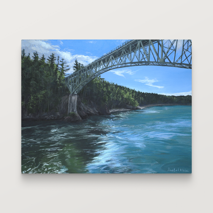 A rectangular canvas print of a landscape painting showing a steel bridge spanning over blue water, with green forested cliffs under a blue sky, displayed against a light gray background.